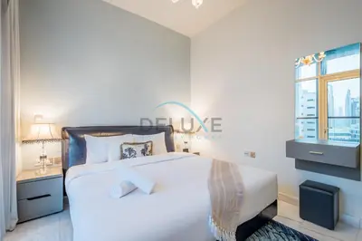 a white bedroom with a large bed and a window at Upscale 3BR Apartment in Bayz Tower, Business Bay by Deluxe Holiday Homes in Dubai