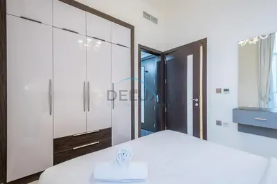a bedroom with a white bed and a large mirror at Upscale 3BR Apartment in Bayz Tower, Business Bay by Deluxe Holiday Homes in Dubai