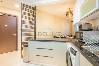 a kitchen with a washer and dryer at Upscale 3BR Apartment in Bayz Tower, Business Bay by Deluxe Holiday Homes in Dubai