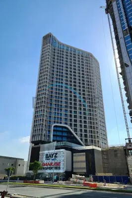 a large building with a sign in front of it at Upscale 3BR Apartment in Bayz Tower, Business Bay by Deluxe Holiday Homes in Dubai