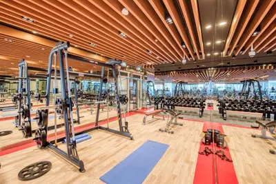 a gym with treadmills and machines in the center at Upscale 3BR Apartment in Bayz Tower, Business Bay by Deluxe Holiday Homes in Dubai