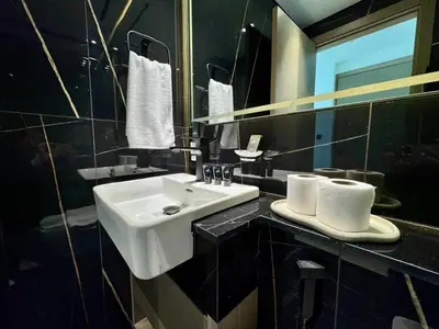 a bathroom with a white sink and a mirror at Stylish 1br Apt In Jvc Pool Access & Parking in Dubai