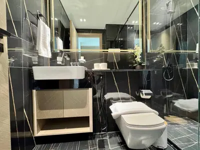 a bathroom with a white toilet and a sink at Stylish 1br Apt In Jvc Pool Access & Parking in Dubai