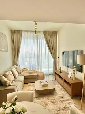 a living room with a couch and a tv at Stylish 1br Apt In Jvc Pool Access & Parking in Dubai