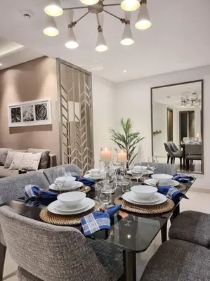 a dining room with a table and chairs at 2 Bedroom DAMAC Prive Apartment in Dubai