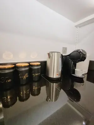 a row of coffee cups on a counter in a kitchen at 2 Bedroom DAMAC Prive Apartment in Dubai