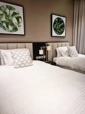 a hotel room with two beds and two lamps at 2 Bedroom DAMAC Prive Apartment in Dubai