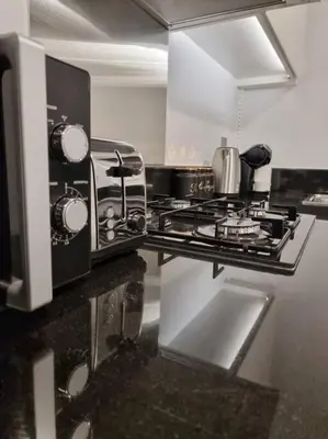 a kitchen with a stove and a microwave at 2 Bedroom DAMAC Prive Apartment in Dubai