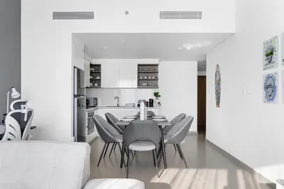 a kitchen and dining room with a table and chairs at Arthouse Views - Burj Khalifa view & Dubai Mall access in Dubai