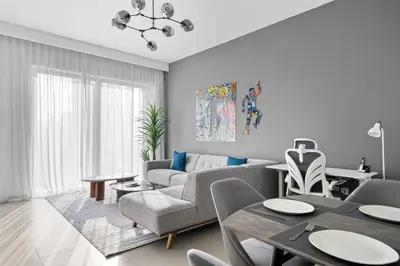 a living room with a couch and a table at Arthouse Views - Burj Khalifa view & Dubai Mall access in Dubai