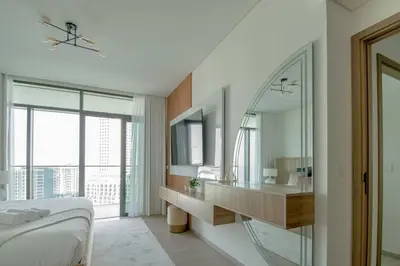 a bedroom with a bed and a large mirror at Waves - Luxurious 11th Floor Retreat in Palace Residences in Dubai
