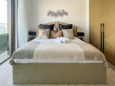 a bedroom with a large bed with two towels on it at Waves - Luxurious 11th Floor Retreat in Palace Residences in Dubai