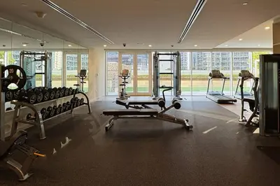 a gym with treadmills and machines in a room at Waves - Canal-View Elegance 1BR Apt in Reva Residences in Dubai