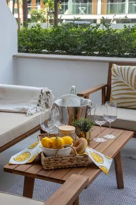 a tray of food on a table with wine glasses at Frank Porter - Azizi Riviera 28 in Dubai