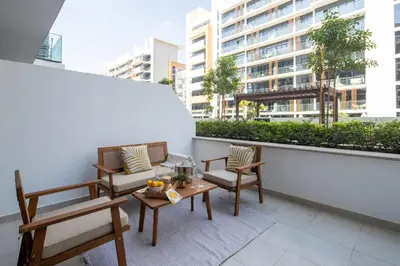 a balcony with two chairs and a table on a building at Frank Porter - Azizi Riviera 28 in Dubai