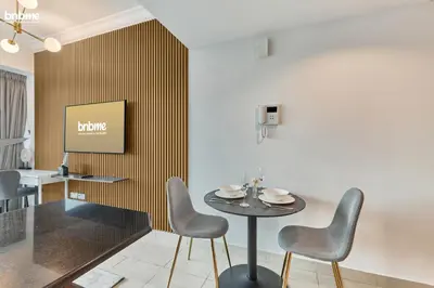 a dining room with a table and chairs at bnbme - Chic Downtown Studio Near Burj Khalifa Dubai Mall w Pool Gym Concierge in Dubai