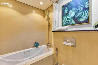 a bathroom with a bath tub and a window at bnbme - Chic Downtown Studio Near Burj Khalifa Dubai Mall w Pool Gym Concierge in Dubai