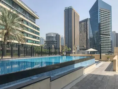 a swimming pool with a city skyline in the background at Marina Quays West - Modern One Bedroom in Marina in Dubai