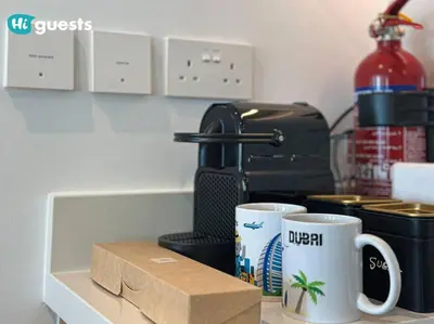 a counter with two coffee cups and a coffee maker at HiGuests - Beachside Oasis Stylish 2BR Apartment in La Vie in Dubai