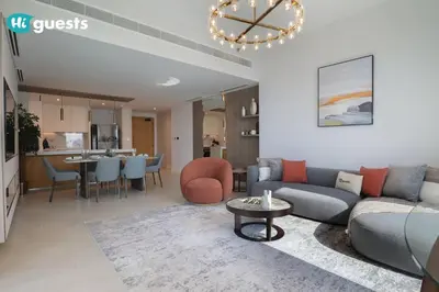 a living room with a couch and a table at HiGuests - Beachside Oasis Stylish 2BR Apartment in La Vie in Dubai