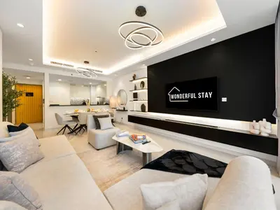 a living room with a couch and a tv at WonderfulStay at Paramount Residences - Highest Infinity Pool - Burj Khalifa View - Brand New Luxury Apartments in Dubai