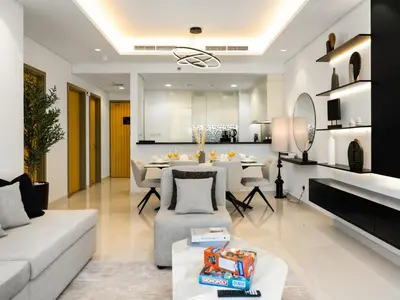 a living room with a couch and a dining room at WonderfulStay at Paramount Residences - Highest Infinity Pool - Burj Khalifa View - Brand New Luxury Apartments in Dubai