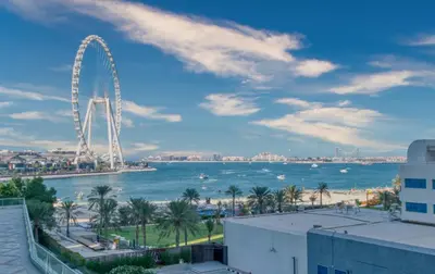 a view of a ferris wheel and the ocean at Artistic Retreat in JBR with Private Beach Access in Dubai