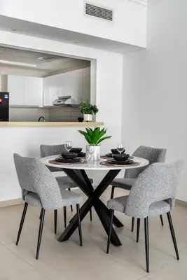 a dining room with a table and chairs at Artistic Retreat in JBR with Private Beach Access in Dubai