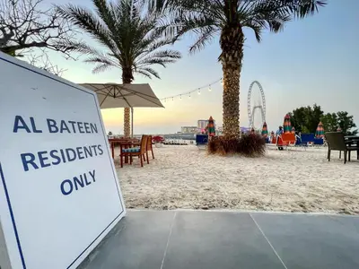 a sign on a beach with a roller coaster at Artistic Retreat in JBR with Private Beach Access in Dubai
