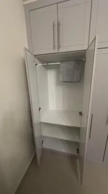 an empty white refrigerator in a white room at Stylish Studio With Amazing View in Dubai