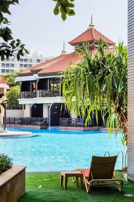 a chair sitting in front of a swimming pool at Palm Jumeirah Studio Sea View Royal Amwaj in Dubai