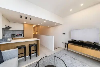a living room with a large white screen on the wall at Palm Jumeirah Studio Sea View Royal Amwaj in Dubai