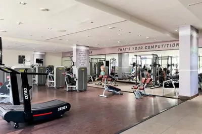 a gym with people working out in a gym at Palm Jumeirah Sea View 1Bdr in Dubai