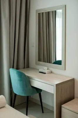 a dressing table with a mirror and a blue chair at Private Beach Palm Jumeirah Studio high floor in Dubai