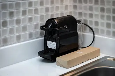a black iron sitting on a counter next to a sink at Private Beach Palm Jumeirah Studio high floor in Dubai