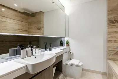 a bathroom with two sinks and a mirror at Downtown Studio Sterling WEST in Dubai