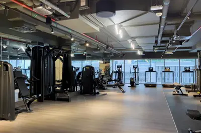 a gym with lots of treadmills and exercise equipment at Downtown Studio Sterling WEST in Dubai