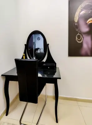a black dressing table with a mirror on it at Elegant Fresh 1BR with Heated Pool, just steps from Mall, Restaurants & Fitness center in Dubai