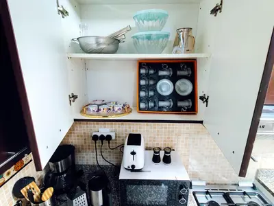 a tiny kitchen with a stove and appliances at Elegant Fresh 1BR with Heated Pool, just steps from Mall, Restaurants & Fitness center in Dubai