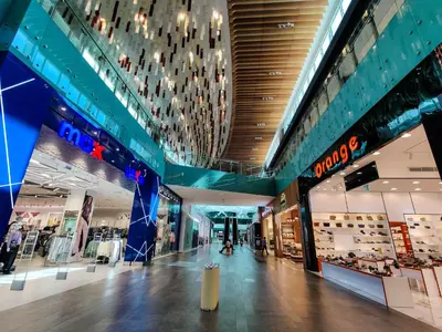 an empty shopping mall with a lot of stores at Elegant Fresh 1BR with Heated Pool, just steps from Mall, Restaurants & Fitness center in Dubai
