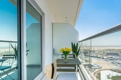 a vase of flowers on a table on a balcony at Best Place 2B Dubai in Dubai