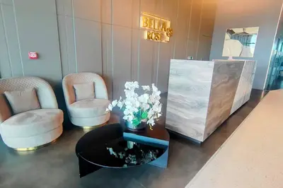 a lobby with two chairs and a table with flowers at Best Place 2B Dubai in Dubai