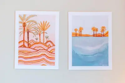 two framed prints of palm trees and a beach at Best Place 2B Dubai in Dubai