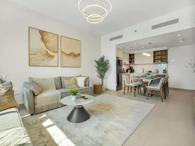 a living room with a couch and a table at Premium Two-Bedroom Apartment with Private Balcony & Full Burj Khalifa Views by Al Fannan Holiday Homes in Dubai