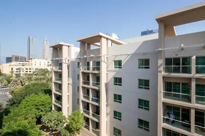 a white building with a city in the background at Frank Porter - Al Dhafrah 2 in Dubai
