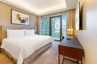 a bedroom with a large white bed and a window at FAM Living - Address Residences Opera - Luxurious 2Bed in Dubai