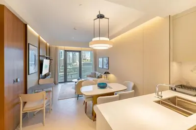 a kitchen and living room with a table and chairs at FAM Living - Address Residences Opera - Luxurious 2Bed in Dubai