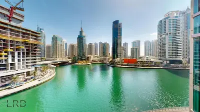 a river in the middle of a city with tall buildings at Luxurious Apartment with Marina Views in Dubai