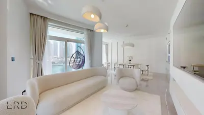 a white living room with a couch and a table at Luxurious Apartment with Marina Views in Dubai