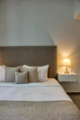 a bedroom with a large white bed with pillows at 1-Bedroom in Merano Tower, Business Bay with City Views in Dubai